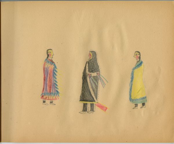 Man in cape flanked by 2 women in fancy blanket shawls